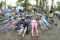 People laying on ground and meditating, yoga instructors playing instrument