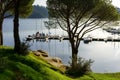 People learning to sail on a sailing boat with a teacher teaching the lesson in the San Juan reservoir in Madrid