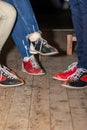 People legs with bowling shoes standing on old wooden floor Royalty Free Stock Photo