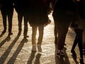 People legs walking in the city at sundown