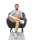 bored man eating popcorn sitting in chair Royalty Free Stock Photo