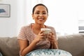 Happy african woman drinking tea or coffee at home Royalty Free Stock Photo