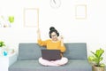 People and leisure concept - happy smiling asian young woman with laptop having fun, resting on weekends at home under quarantine