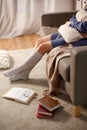 woman in socks with pillow and books at home Royalty Free Stock Photo