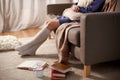 woman in socks with pillow and books at home Royalty Free Stock Photo