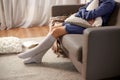 woman in socks with pillow sitting on sofa at home Royalty Free Stock Photo