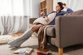 woman with pillow and books on floor at home Royalty Free Stock Photo