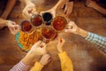 People, leisure, friendship and communication concept - happy friends drinking beer, talking and clinking glasses at bar Royalty Free Stock Photo