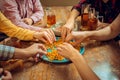 People, leisure, friendship and communication concept - happy friends drinking beer, talking and clinking glasses at bar Royalty Free Stock Photo