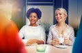 Happy young women drinking tea or coffee at cafe Royalty Free Stock Photo