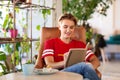 Teenage girl with notebook at coffee shop or cafe