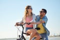 Happy young couple riding bicycle at seaside Royalty Free Stock Photo