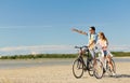 Happy young couple riding bicycles at seaside Royalty Free Stock Photo