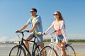 Happy young couple riding bicycles at seaside Royalty Free Stock Photo