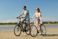 Happy young couple riding bicycles at seaside Royalty Free Stock Photo