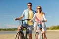 Happy young couple riding bicycles at seaside Royalty Free Stock Photo