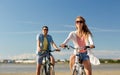 Happy young couple riding bicycles at seaside Royalty Free Stock Photo