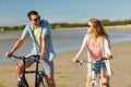 Happy young couple riding bicycles at seaside Royalty Free Stock Photo