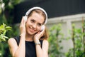 People leisure and technology concept - Attractive young woman listening to music on the music player in outdoors.