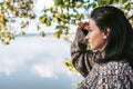 People, liefstyle and travel concept. Side view of beautiful brunette Caucasian young female traveler looks afar, posing against