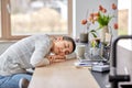 Tired woman sleeping on table with laptop at home Royalty Free Stock Photo