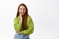 People and lifestyle. Happy young woman with red long hair, laughing and smiling white teeth, chuckle and having fun