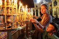 People light candles in Sveti Sedmochislenitsi Church during a big holiday in Sofia, Bulgaria on july 27, 2012