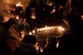 People light small candles on the street in the dark