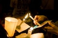 People lighting candle vigil in darkness seeking hope, worship, Royalty Free Stock Photo