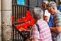 People lighting candles