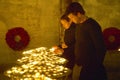 People lighting candles inside the Notre Dame Cathedral, Paris, France