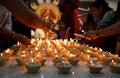 People lighting oil lamps for Sandhi puja during Durga Puja festival celebration in Manama, Bahrain