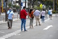 People lining in a queue practicing social distancing