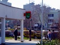 People lining up in front of the post office at a 2 meter distance