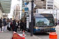 People lining up to board a Translink bus on West Georgia Street in Downtown Vancouver