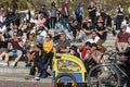 People listen to the music of street musicians sitting on the steps on Paseo Joan De Borbo