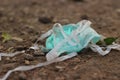 People littering garbage of used medical masks throw in the crevices of the bushes. It can be a hazardous waste, with risk of