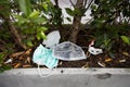 People littering of garbage of used medical masks throw in the crevices of the bushes,hazardous waste,risk of disease,spread of