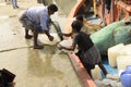 people loading ice blocks, fishing nets for fishing voyage at Frezarganj fish harbor, west Bengal, india