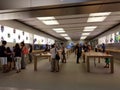 People look at Iphone, Ipad, headphones, laptop and other products at busy The Apple retail store