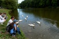 People look at the swans in the Moscow Park `Tsaritsyno`.