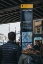 People looking for directions on a sign and map in Camden Town, London, UK Royalty Free Stock Photo