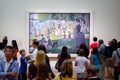 People looking at a famous painting