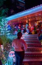 People looking at fancy Christmas decoration of the facade of a house in Villavicencio