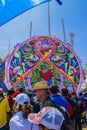 people looking at the giant colorful kite with Mayan figures with indigenous woman