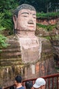 People looking at The majestic Giant Leshan Buddha