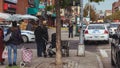 People looking at a policeman near crime scene in Harlem