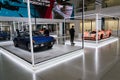 People looking at Porsche sports cars standing at Volkswagen Group forum Drive in Berlin, Germany