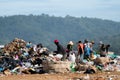 People looking through rubbish on landfill site Royalty Free Stock Photo