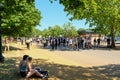 A young couple looking at a large group of protesters in Hyde park